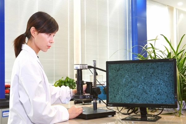 A highly trained SQG laboratory technician performing technical assessments to ensure safety glove compliance.