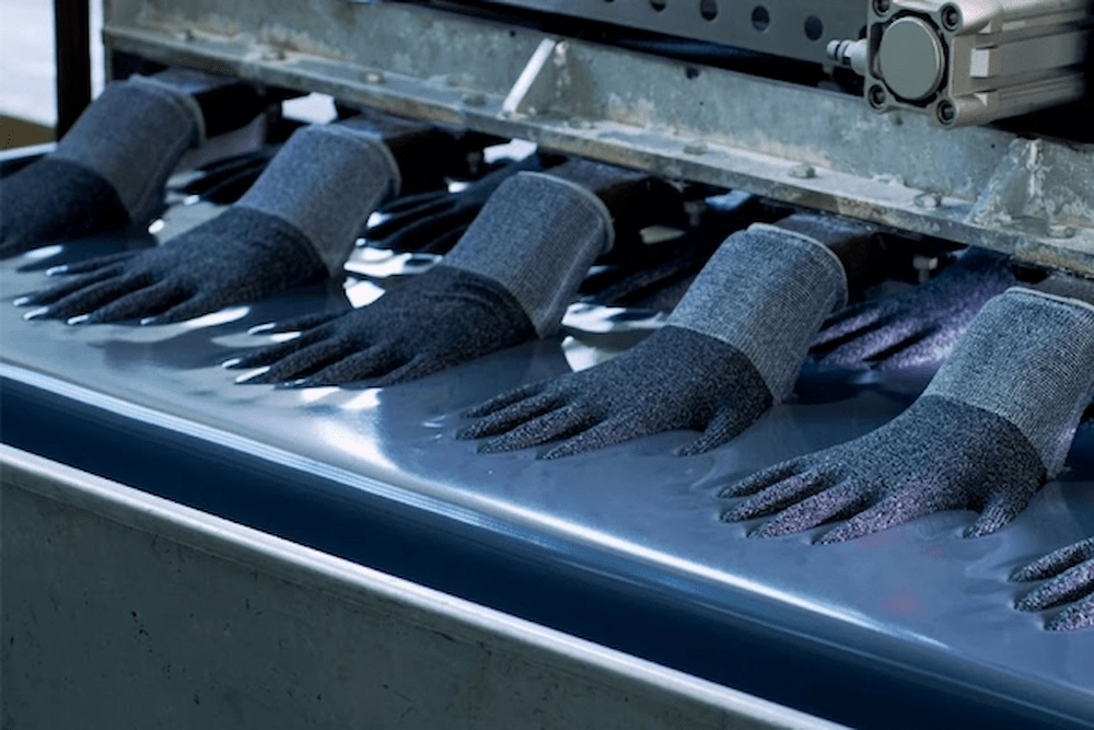 Fully automated safety glove dipping process ensuring consistent coating quality