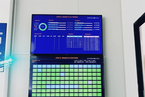 Industrial worker using touchscreen HMI terminal in a digitized lean manufacturing facility